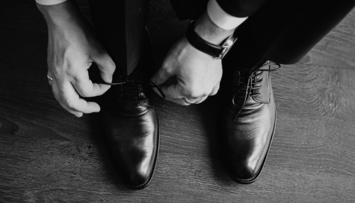 Businessman tying shoelaces
