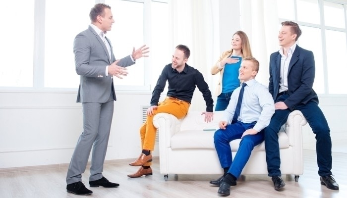 good boss talking to smiling employees