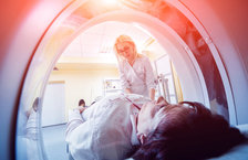 Female doctor preparing a patient for a CT scan