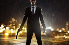 Young man holding a gun during a rainy night
