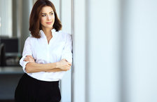 Confident business woman looking out of office window