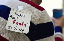Close-up of a sticky note that says 'Happy April Fools' Day' stuck on a man's back