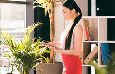 An Asian businesswoman using a digital tablet in an office
