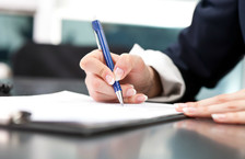 Close-up of a businesswoman signing a document